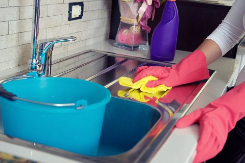 Cleaner working carefully on a surface during a scheduled service